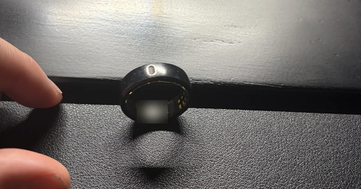 Our own Oura Ring Gen3 in matte black after more than a year of nightly wear, showing the inner sensors and Oura branding
